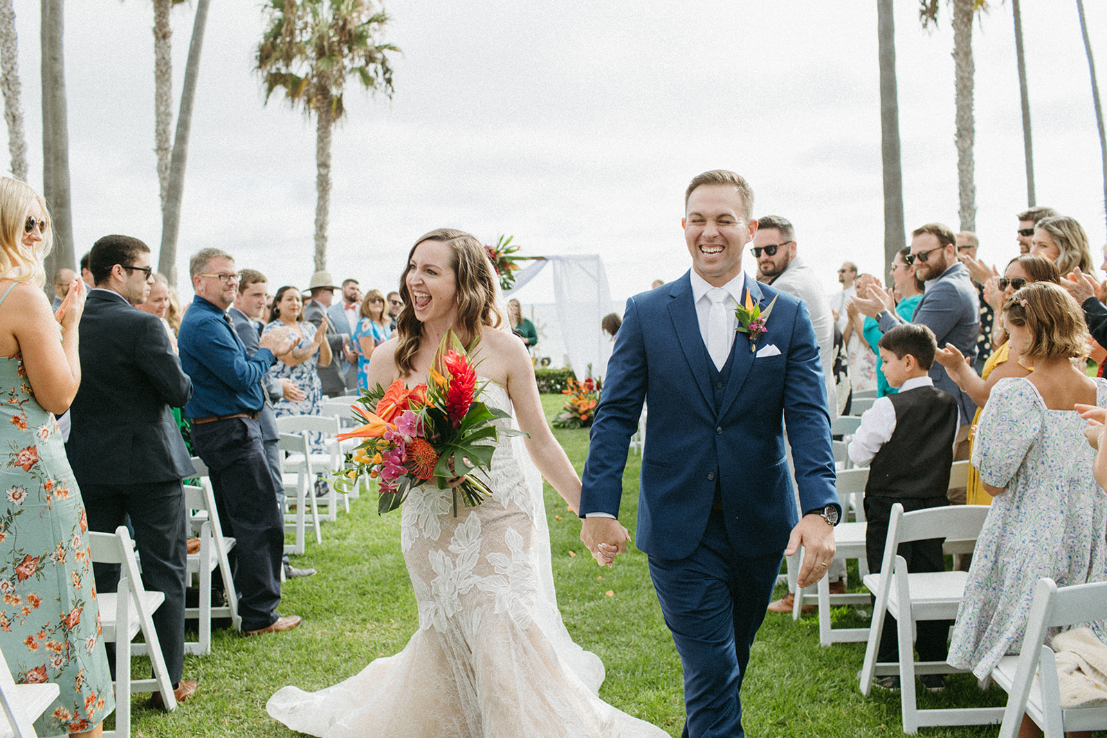 bride and groom recessional during tropical wedding ceremony at Ole Hanson Beach Club