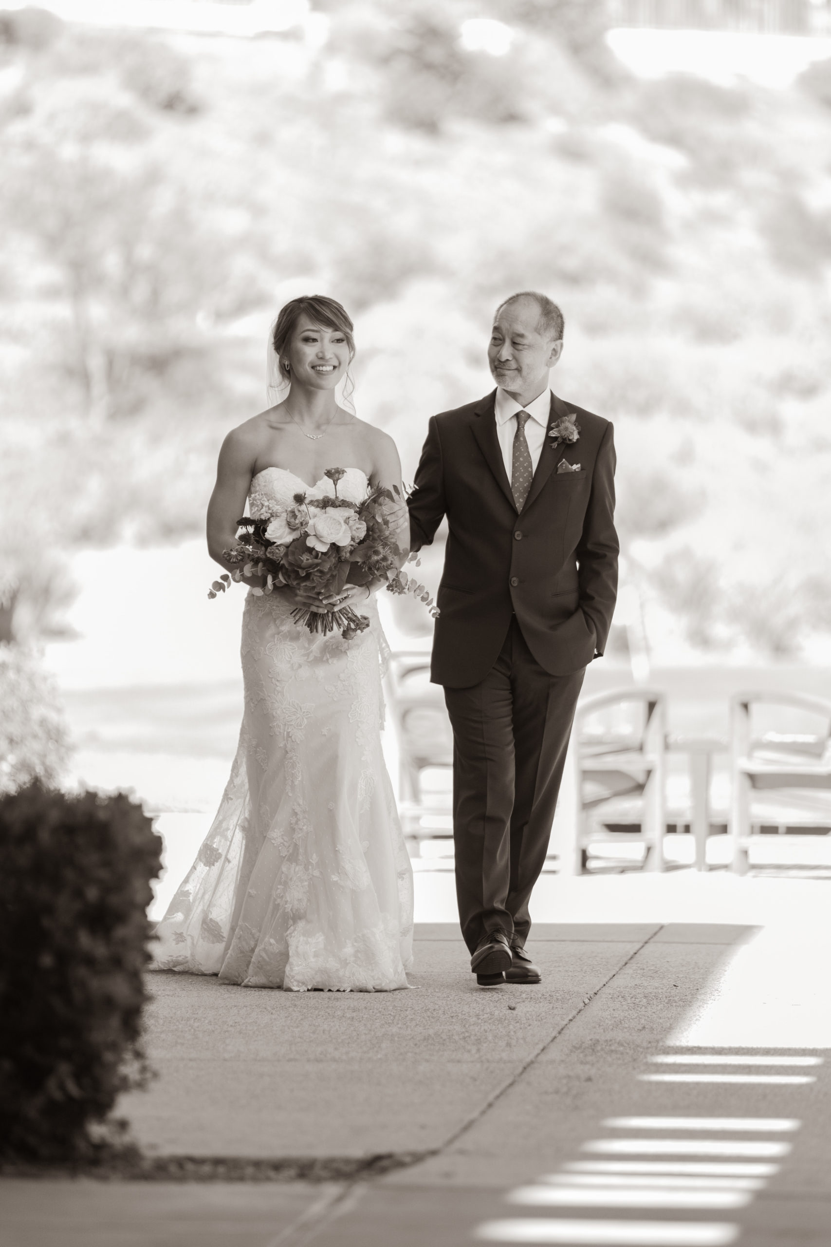 black and white photo of bride walking with father of brid