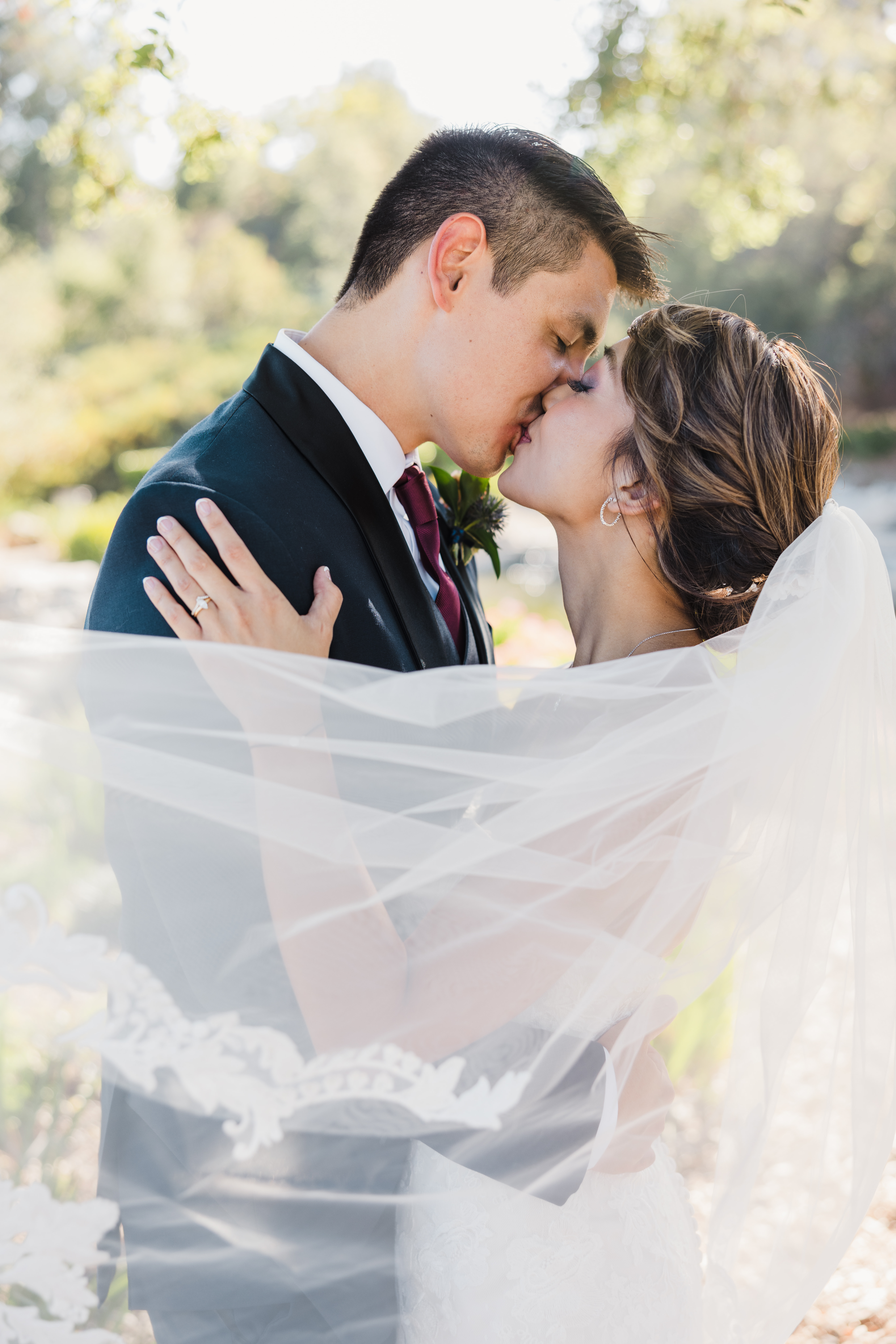 bride in strapless lace wedding dress and groom in navy tuxedo take outdoor portrait photos around Dove Canyon Golf Club