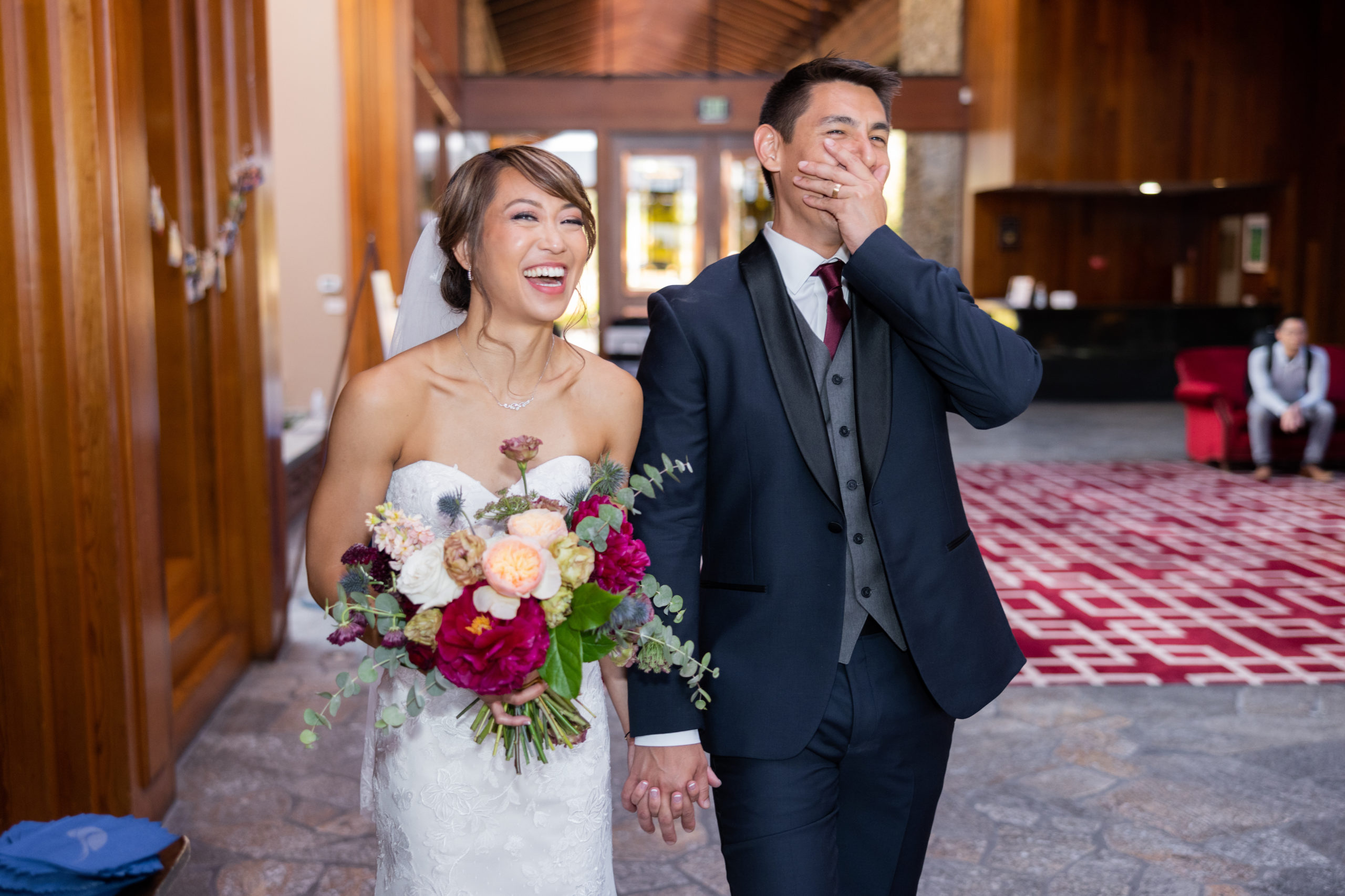 bride and groom walk into wedding reception surprised
