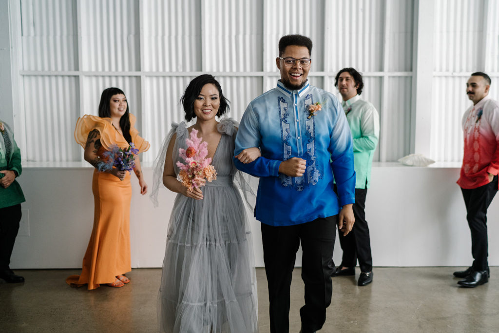 rainbow inspired wedding party outfits during recessional at The Revery