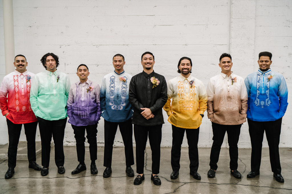 groom stands with groomsmen in rainbow inspired outfits