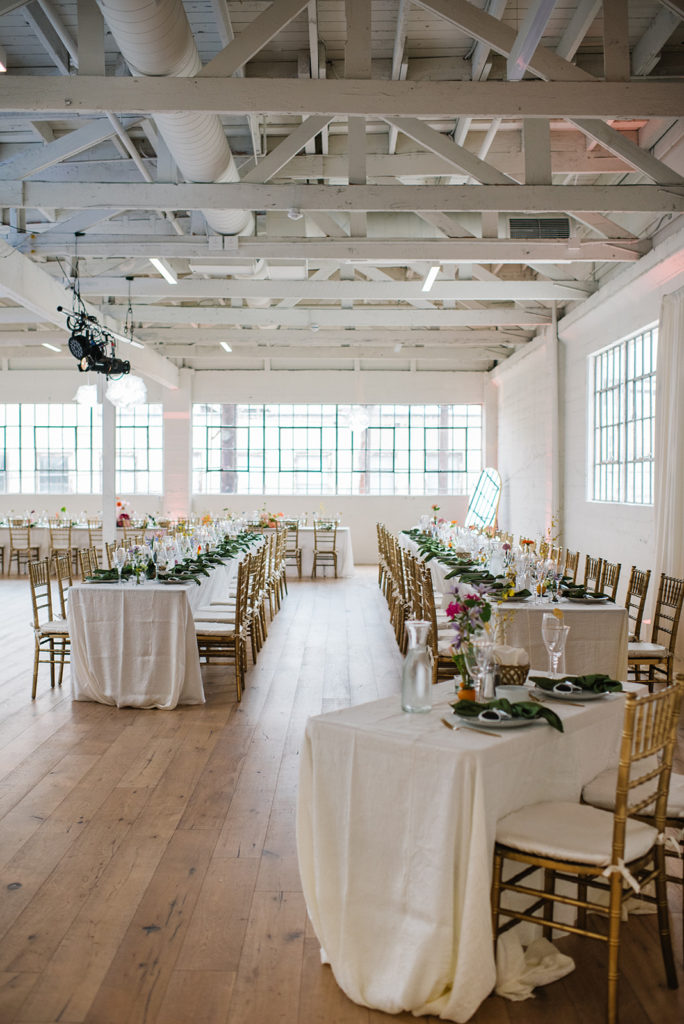 cloud themed wedding reception with disco balls and rainbow inspired floral arrangements at The Revery