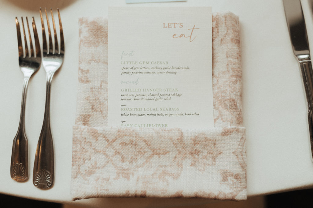 pink patterned napkin with menu for wedding reception dinner
