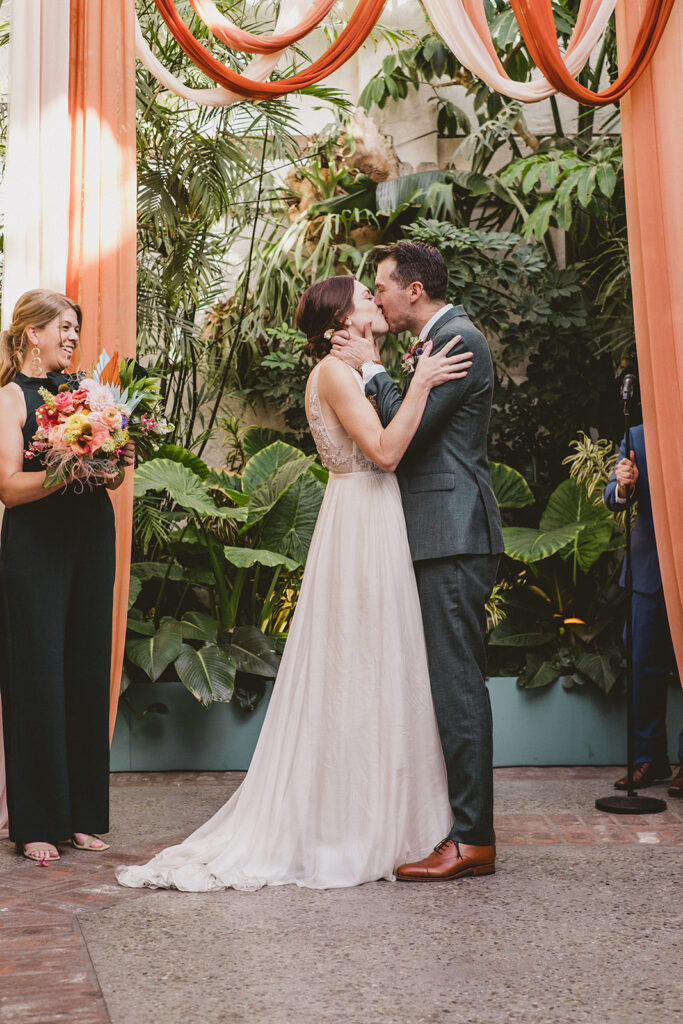 bride and groom first kiss jungle disco themed wedding ceremony at Valentine DTLA