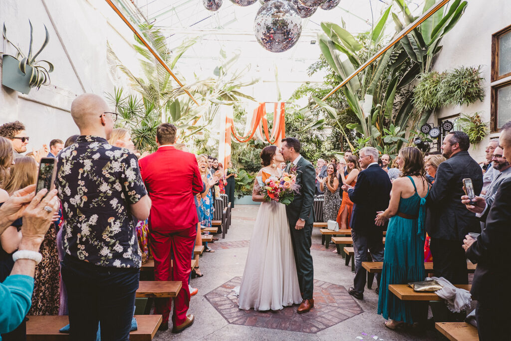 bride and groom recessional after jungle disco themed wedding ceremony at Valentine DTLA