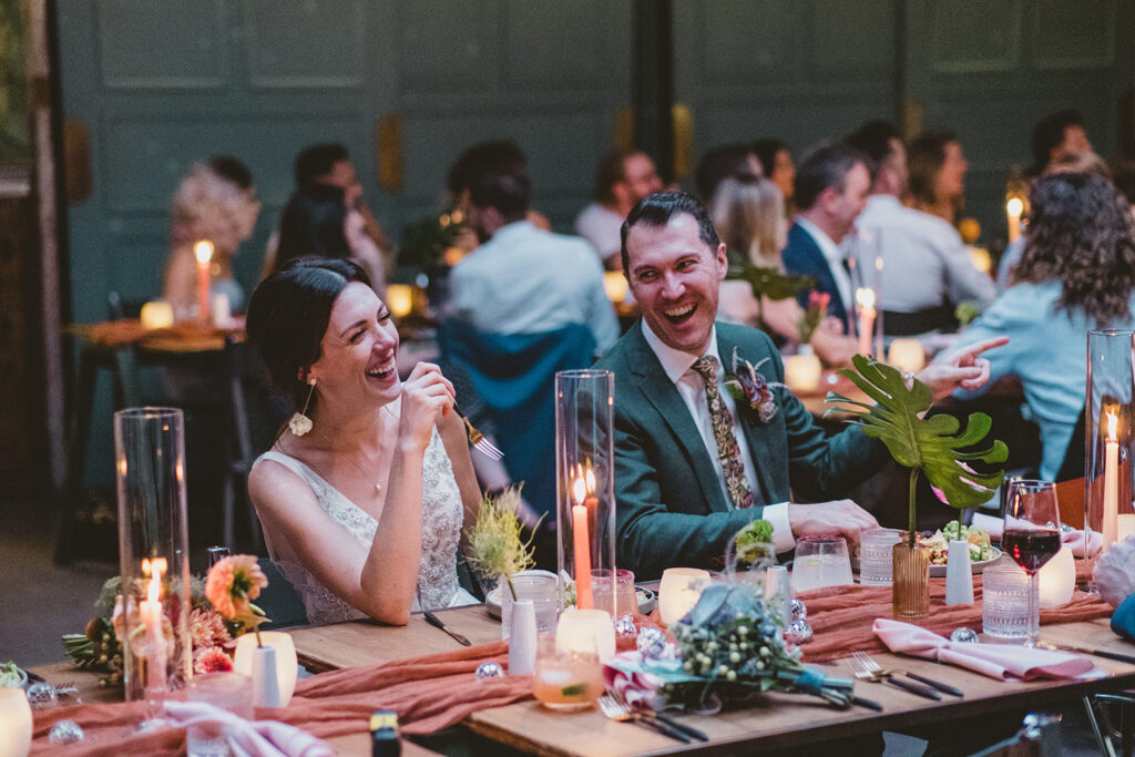 bride and groom laughing during jungle disco themed wedding reception at Valentine DTLA