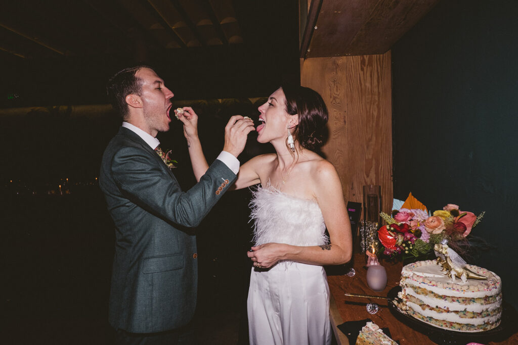 bride and groom feeding one another cake