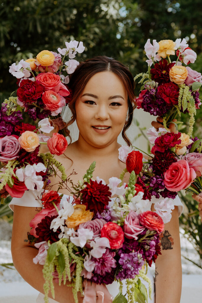 bride surrounded by eclectic colorful bouquets