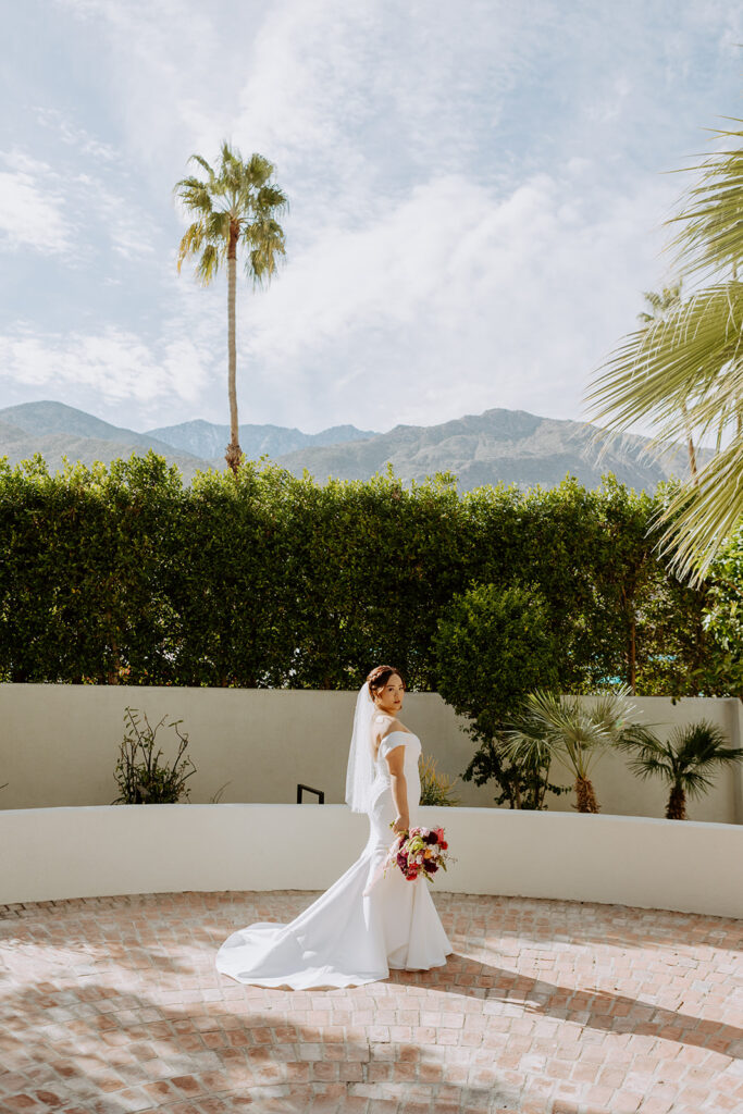 bride in minimalist off shoulder wedding dress portrait shots in Palm Springs