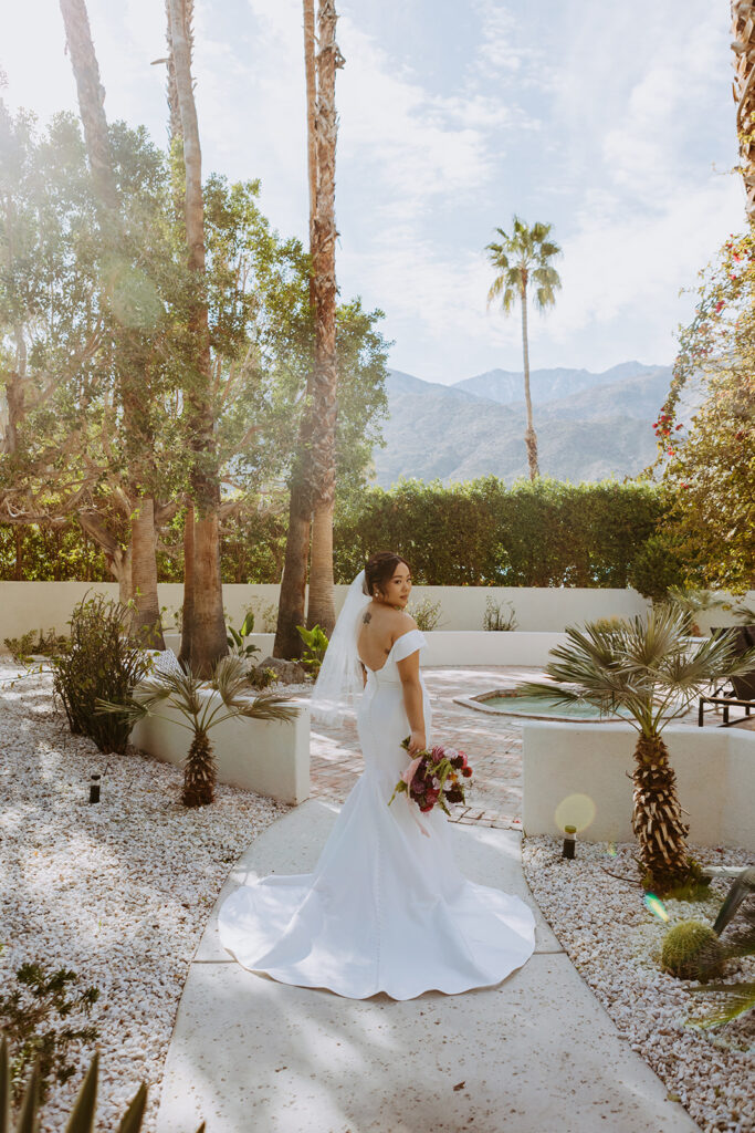 bride in minimalist off shoulder wedding dress portrait shots in Palm Springs