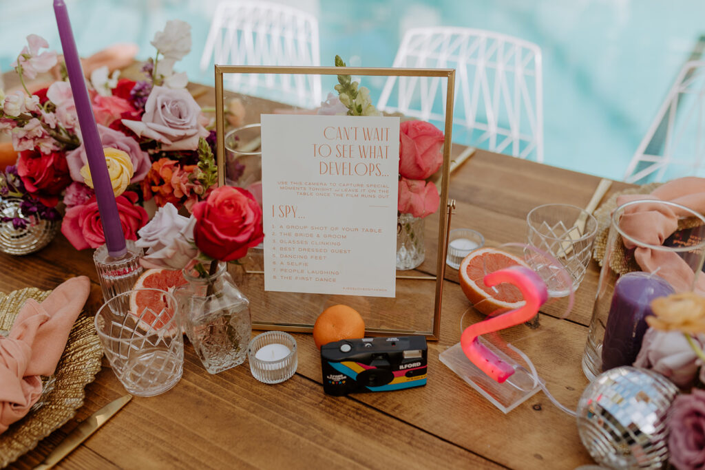 disposable camera with photography prompts at pool side wedding reception 