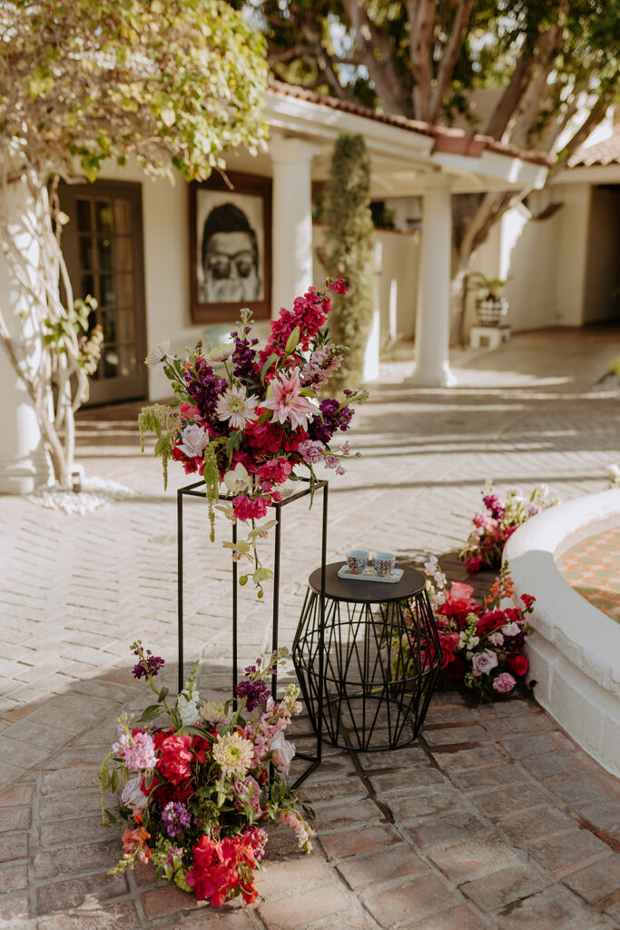 Ceremony in the Royal Villa Palm Springs Courtyard with colorful eclectic floral arrangements