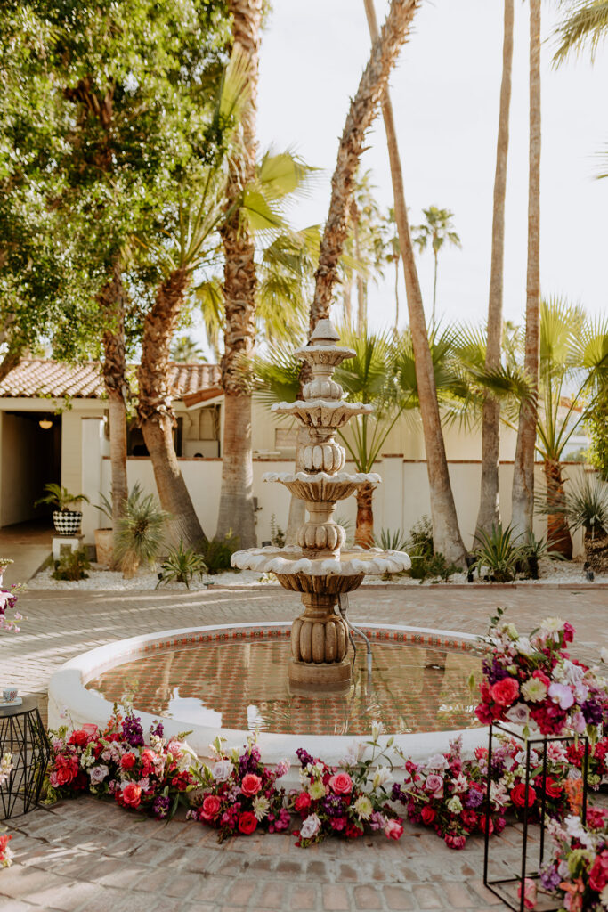 Ceremony in the Royal Villa Palm Springs Courtyard with colorful eclectic floral arrangements