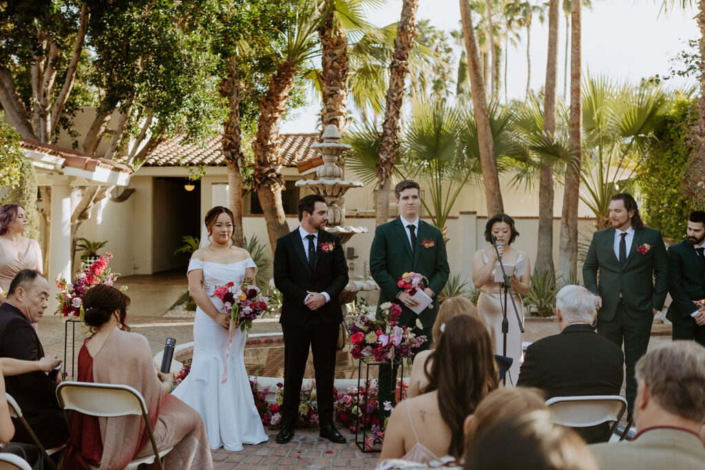 wedding ceremony in front of fountain at Villa Royal Palm Springs