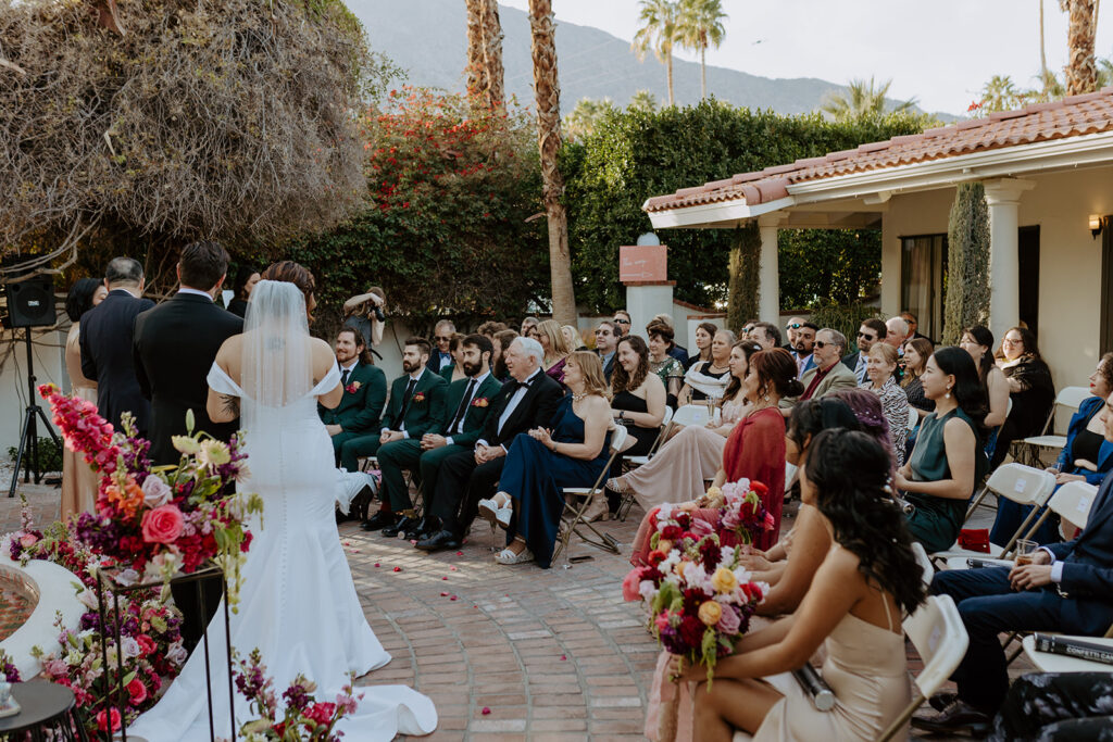 wedding ceremony in front of fountain at Villa Royal Palm Springs