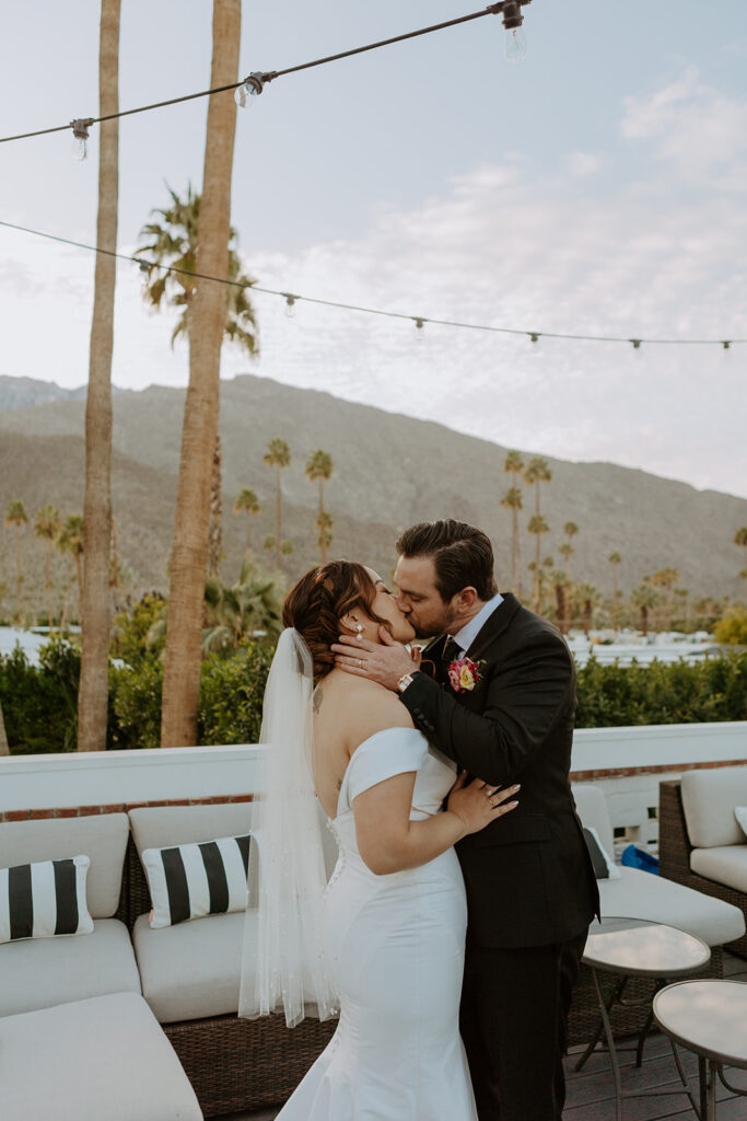 bride in minimalist off shoulder wedding dress and groom in black suit sunset photos in Palm Springs