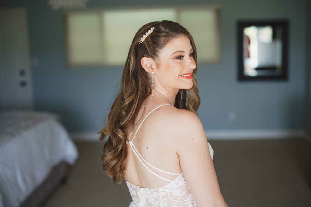 long bridal hair with deep side part and pearl hair clip 