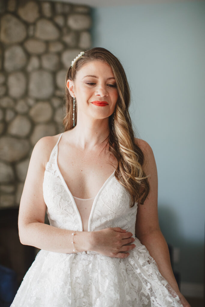 long bridal hair with deep side part and pearl hair clip and red lipstick