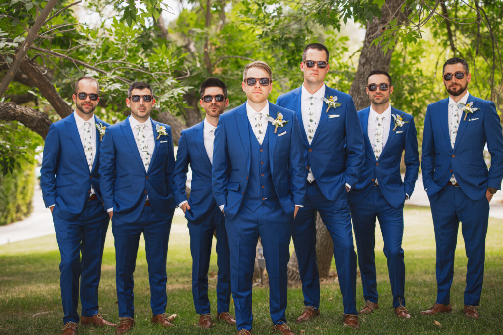 groom and groomsmen in blue suits and billy ball boutonnieres 