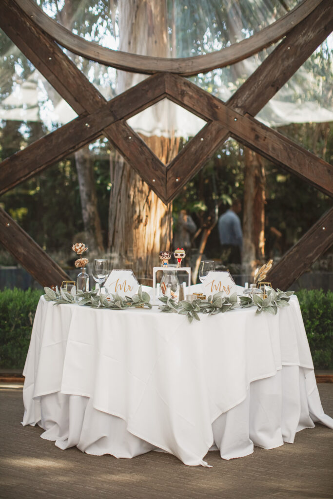 quirky wedding reception in the Oak Room at Calamigos Ranch with yellow napkins, dried floral arrangements and pop funk table numbers