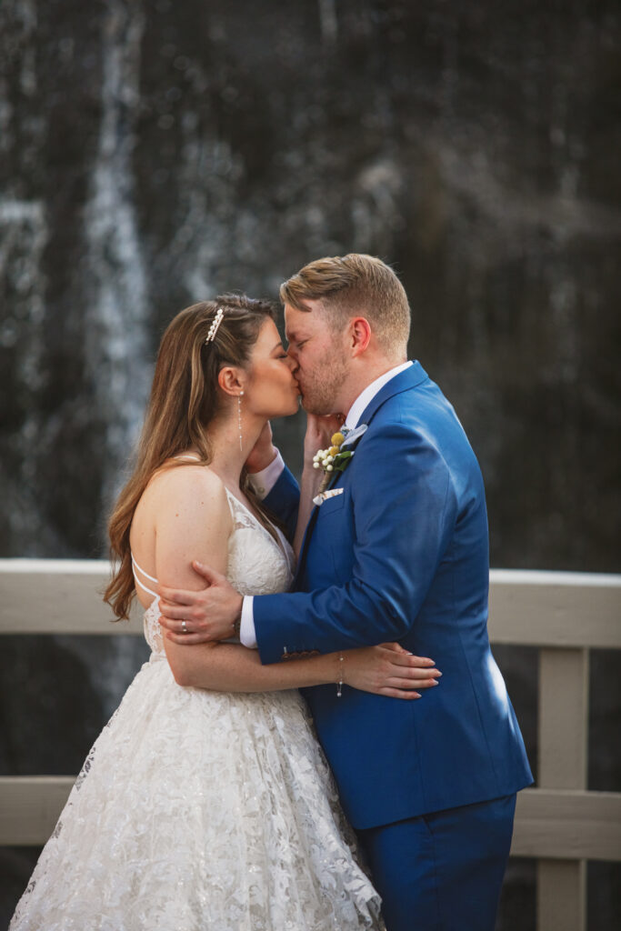 bride and groom first kiss during wedding ceremony at Calamigos Ranch Oak Room