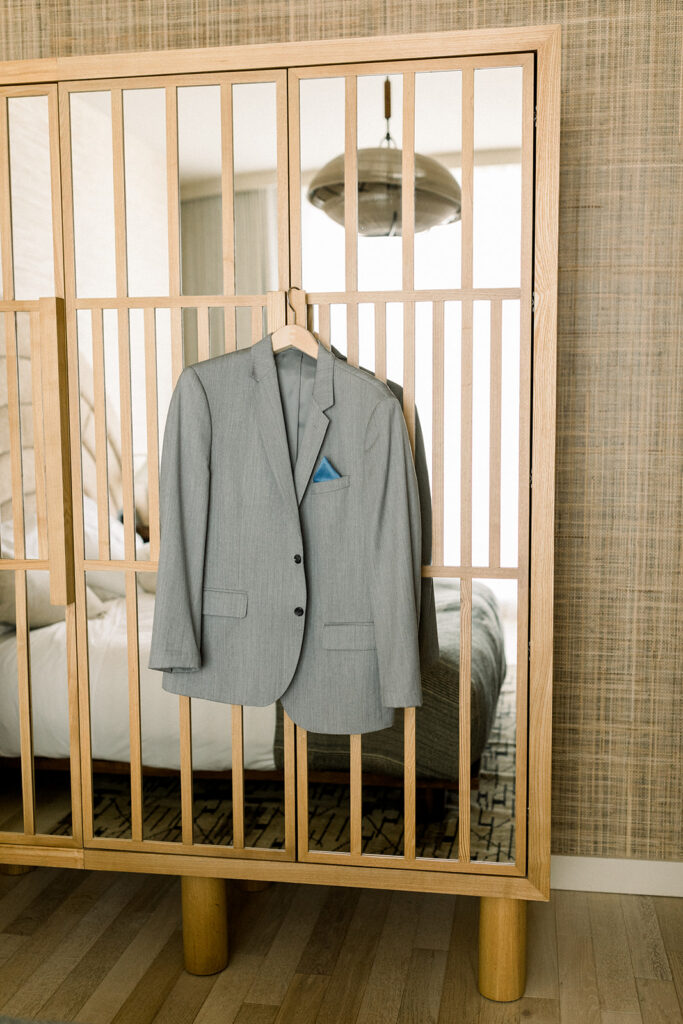 grey groom suit jacket with blue pocket square