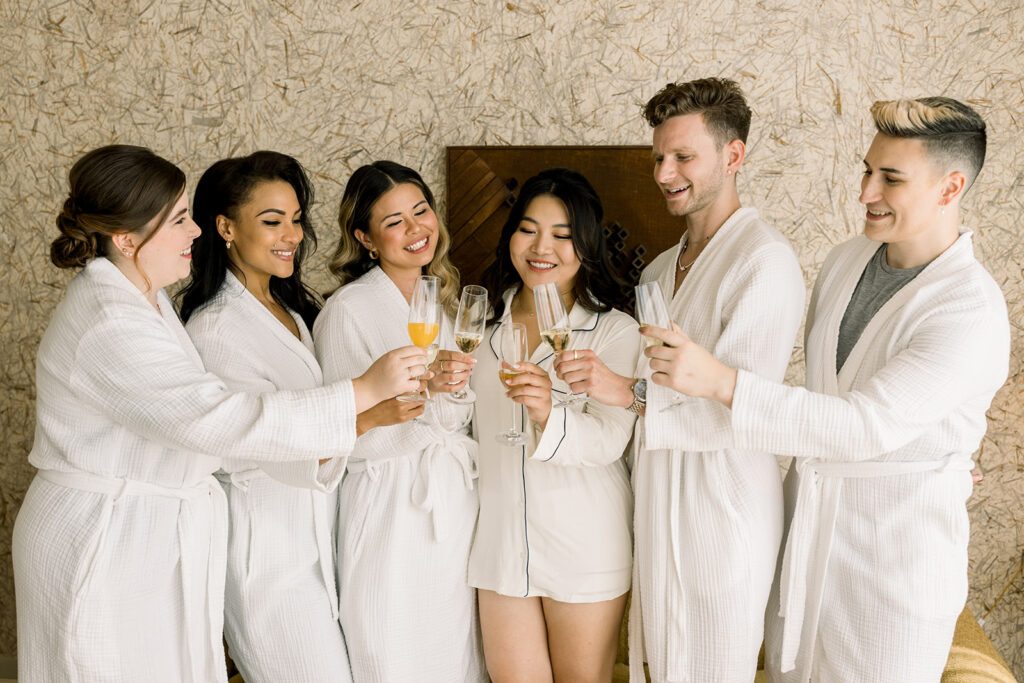 bride cheers with bridal party