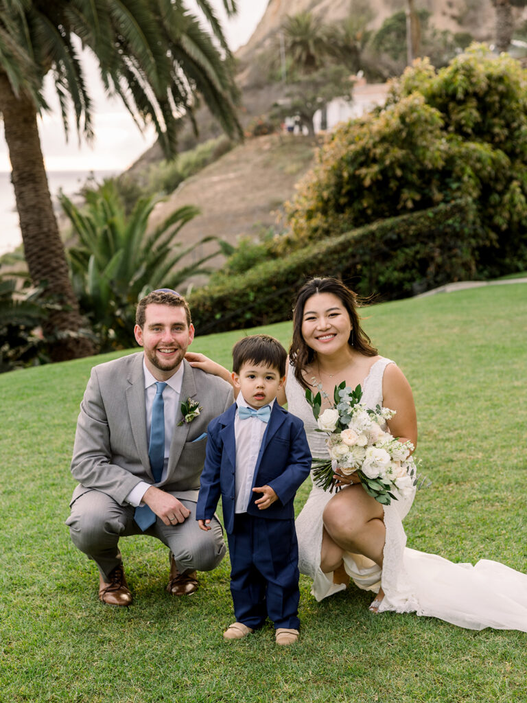 bride dog room with young ring bearer in navy blue suit