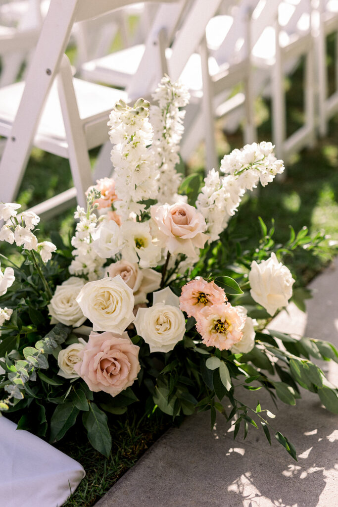 soft pink and white aisle floral arrangement