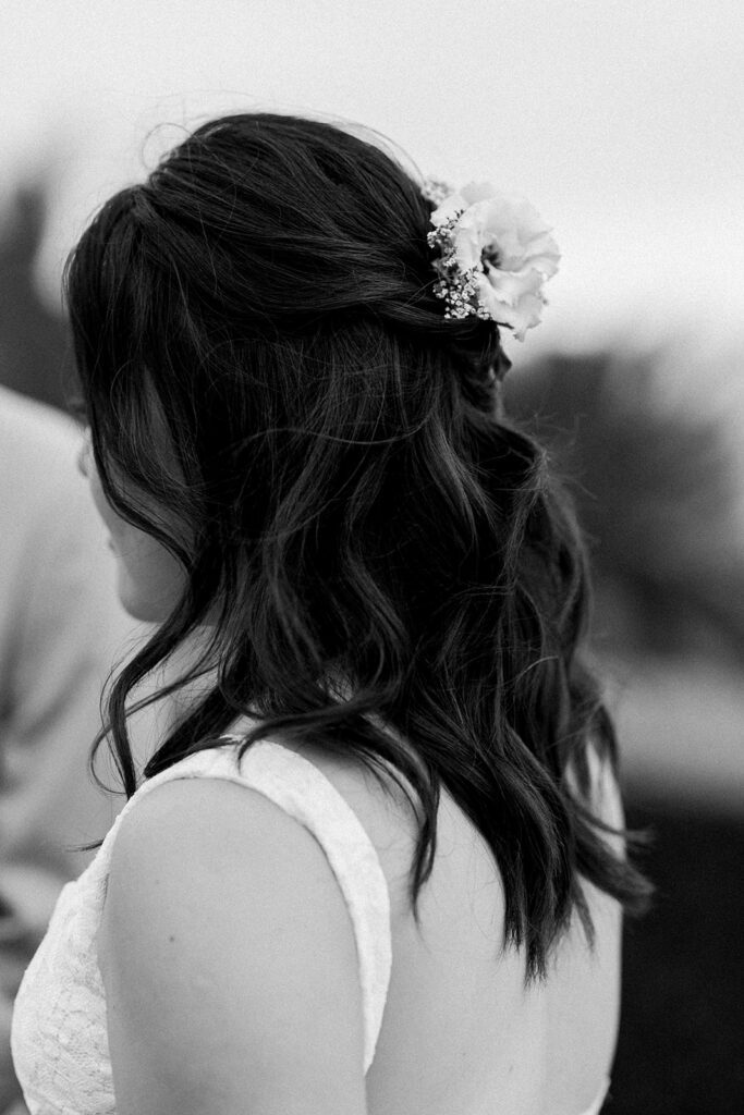 bridal hair with soft curls and half up-do with floral piece 