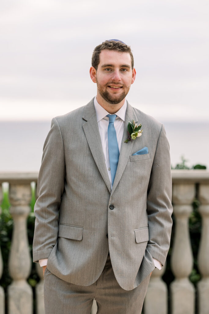 groom in light grey suit and blue tie at Bel Air Bay Club