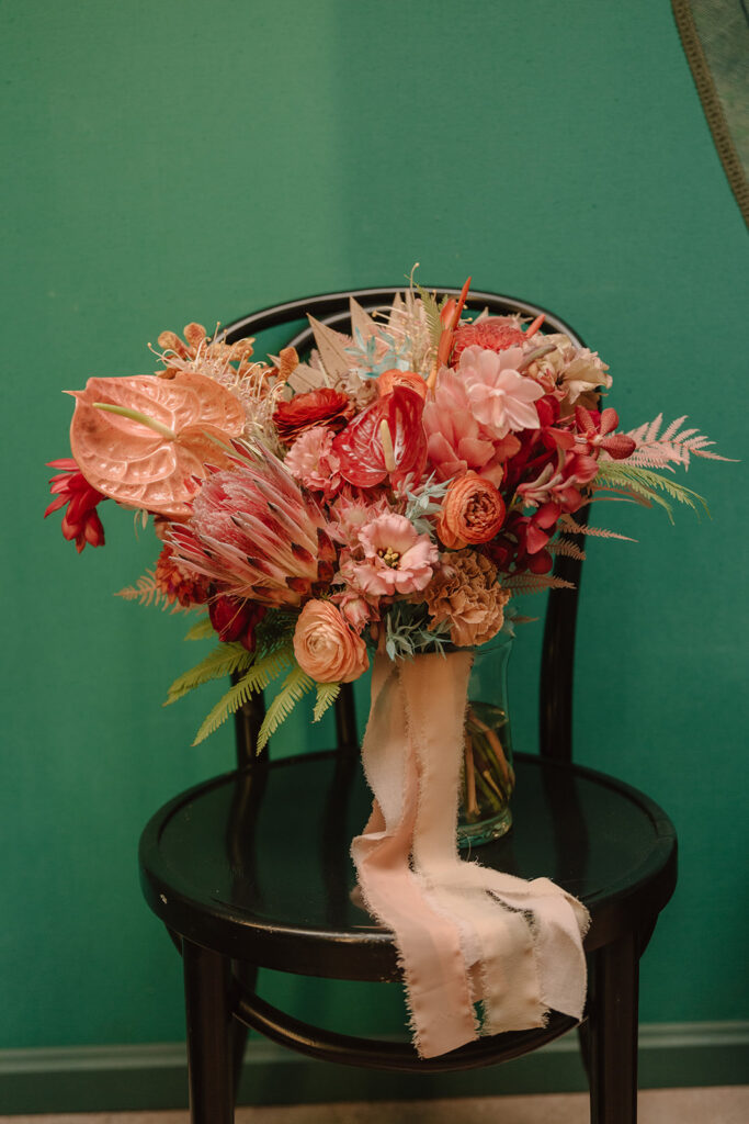 pink tropical bridal bouquet with a mix of dried florals, king protea and anthurium