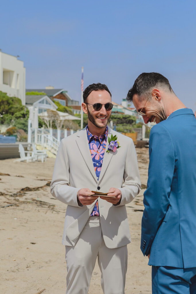 grooms exchange vows during private beach wedding ceremony