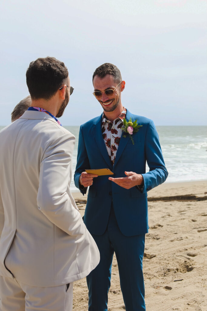 grooms exchange vows during private beach wedding ceremony