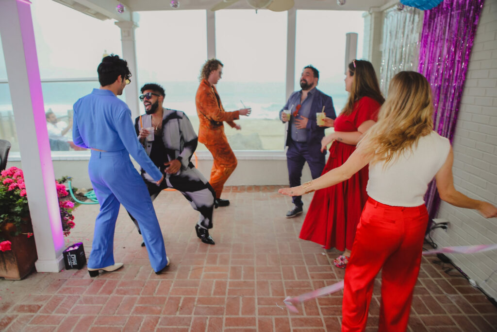 guests dancing during outdoor wedding reception at private beach house