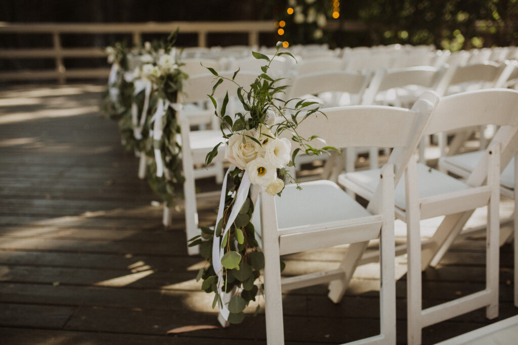 waterfall wedding ceremony at The Oak Room at Calamigos Ranch with white floral arrangements 
