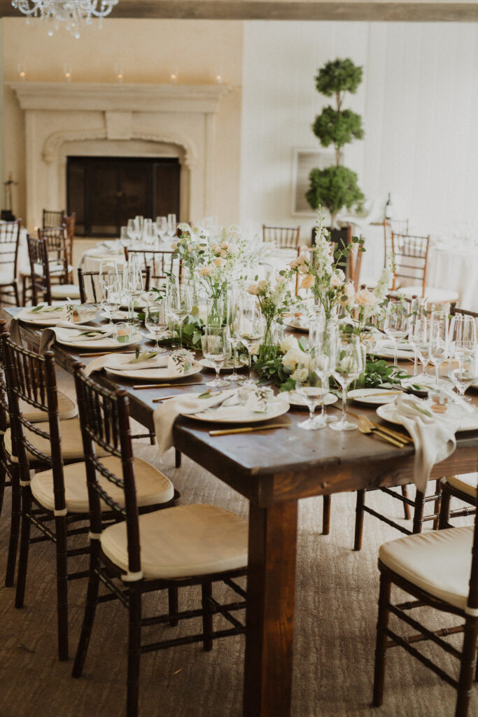 soft gold wedding reception at the Oak Room at Calamigos Ranch with farm tables and white floral arrangements
