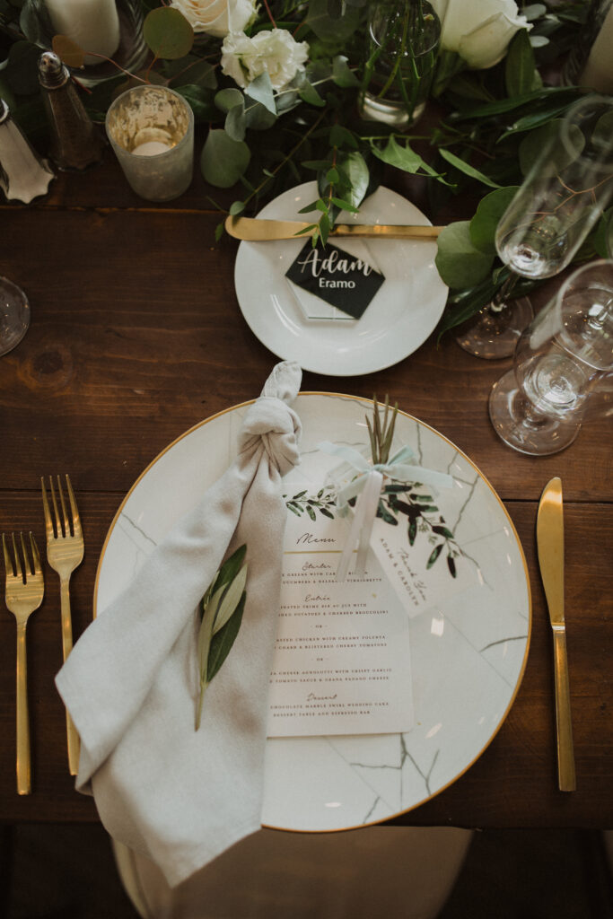 soft gold wedding reception at the Oak Room at Calamigos Ranch with farm tables and white floral arrangements and gold cutlery