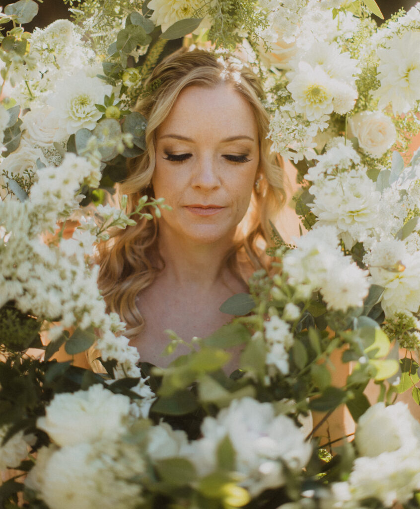 bride surrounded by white bouquets