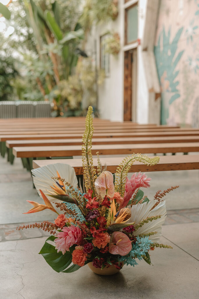 wedding ceremony at Valentine DTLA with pink tropical floral arrangements 