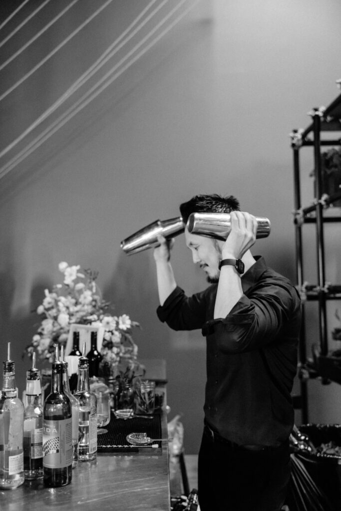 black and white photo of bartender shaking drinks