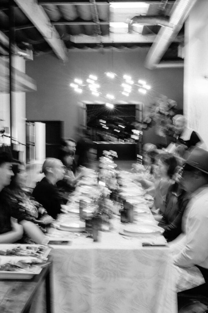 blurry black and white photo of dinner party