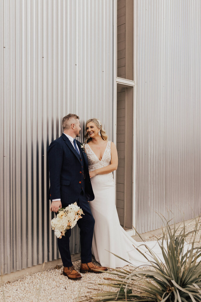 bride in deep v-neck wedding dress with lace elements and groom in navy blue suit at Prospect House for their destination wedding