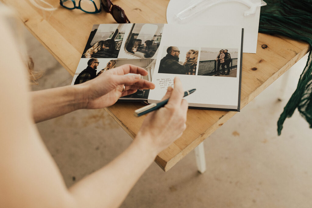 guests signing welcome book with engagement photos of couple