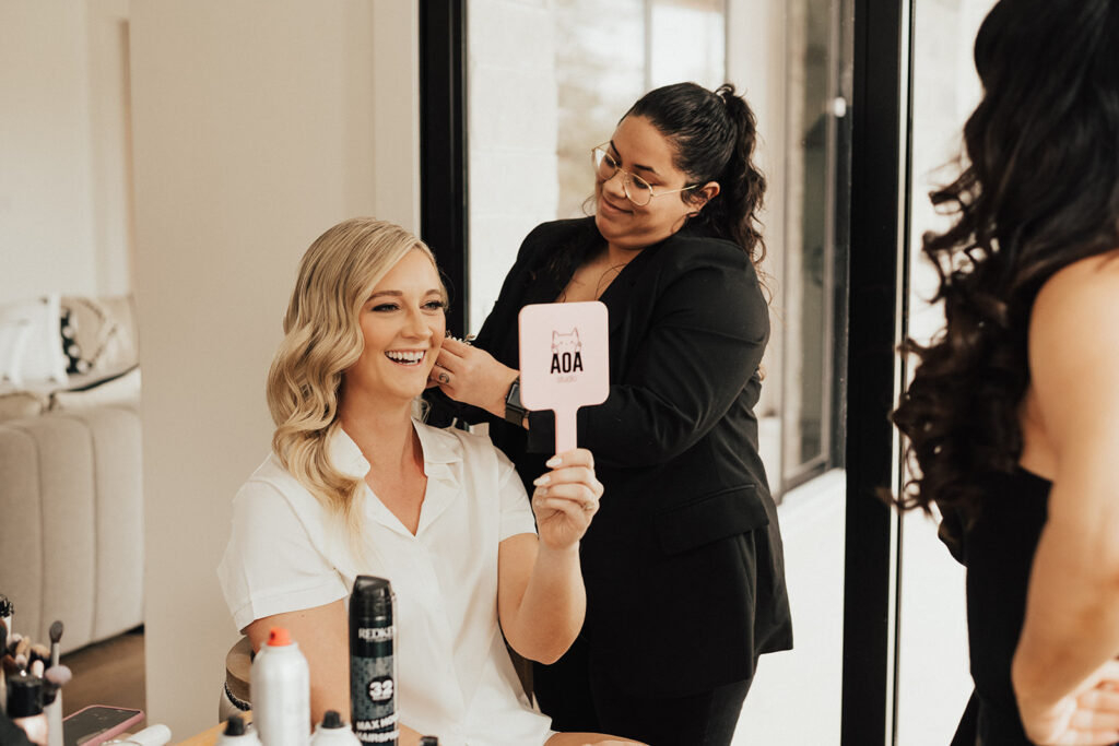 bride to be checking out makeup in mirror