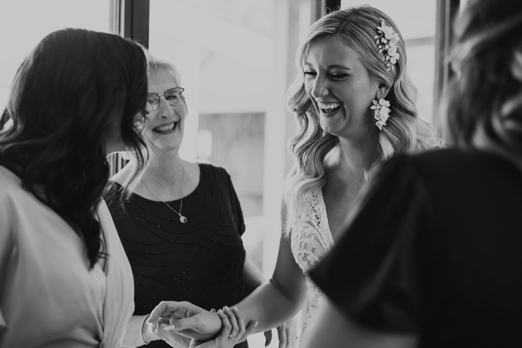 black and white photo of bride laughing with mother of bride
