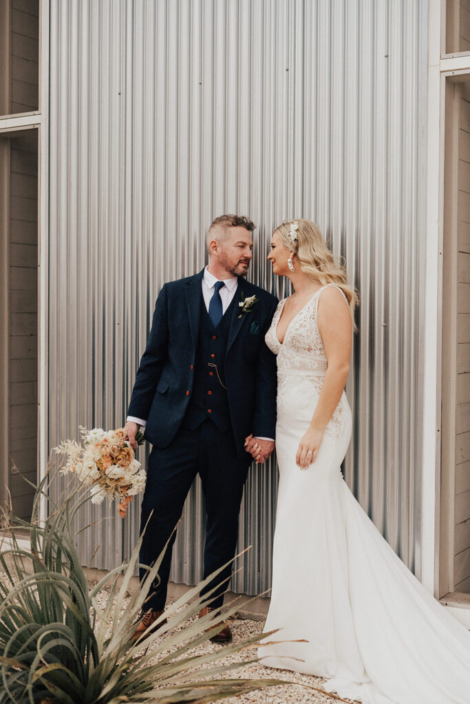 bride in deep v-neck wedding dress with lace elements and groom in navy blue suit at Prospect House for their destination wedding