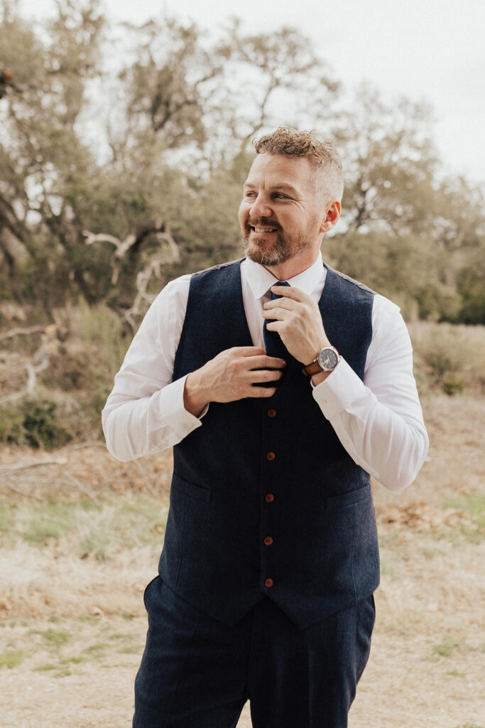 groom in navy vest with brown shoes