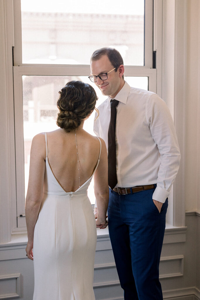 bride in minimalist wedding dress with necklace chain down the back